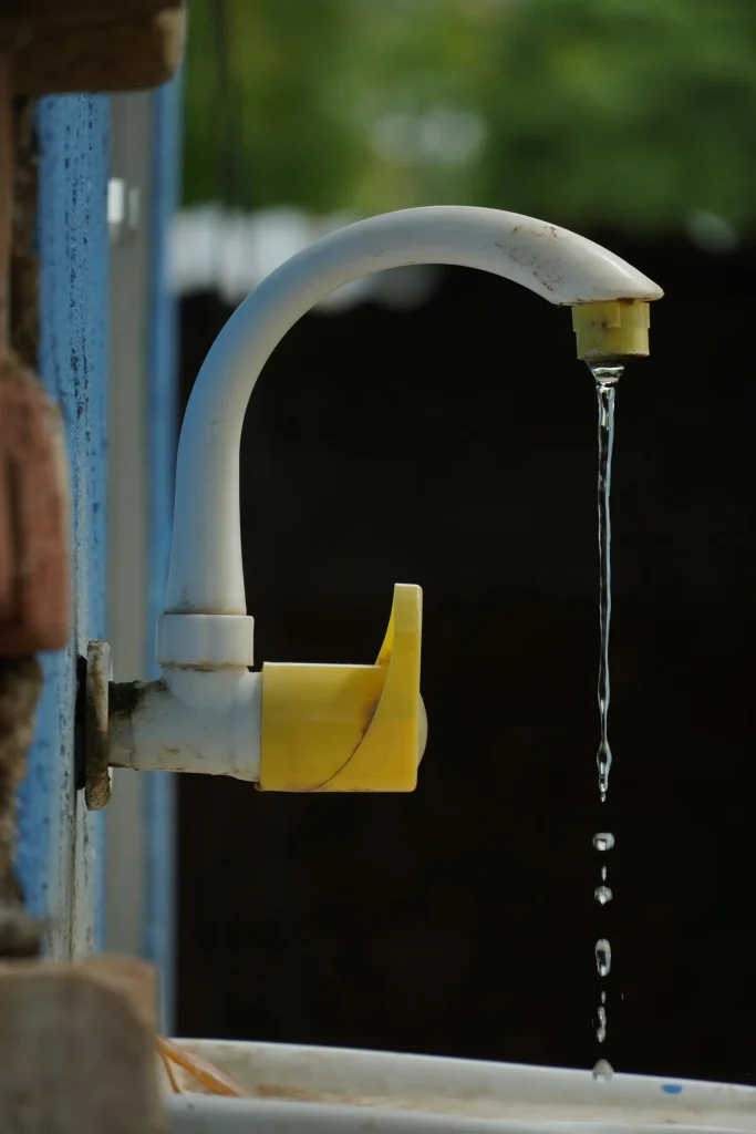 Dripping tap wasting water, a common sign of a plumbing leak